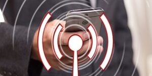 Hand holding a cellphone with a Wifi icon